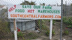 A sign at the fenceline of South Central Farm