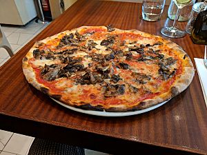 Thin crust Roman style pizza on table
