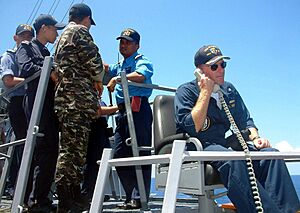 US Navy 040527-N-4104L-001 Guided missile destroyer USS Russell (DDG 59), Commanding Officer, Cmdr. William Kearns III, communicates with his combat information center