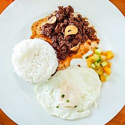 Beef tapa with steamed rice and sliced tomato and cucumber.jpg
