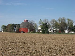 Round red barn and farmhouse