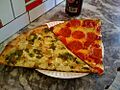Pepperoni and chicken pesto pizza slices