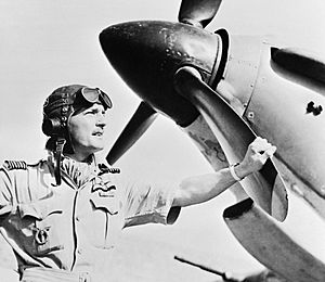 Wing Commander Frank Carey, Officer Commanding the Air Firing Training Unit, based at Amarda Road, India, standing by the nose of a Hawker Hurricane, April 1943. CI171.jpg