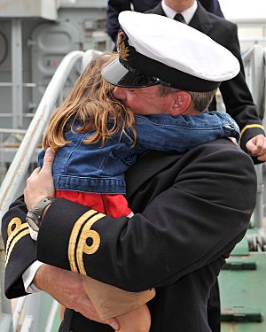 A Royal Navy Officer Hugs His Daughter After Returning from a Long Deployment on HMS Chiddingfold MOD 45153053