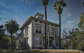 Photograph of the Victorian John Muir House from street level, looking up at the house and its pergola against the sky.