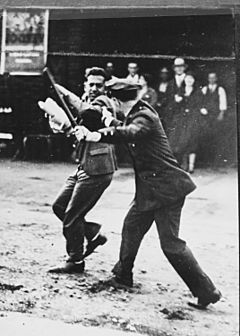 Confrontation between a policeman wielding a night stick and a striker during the San Francisco General Strike, 1934 - NARA - 541926.jpg