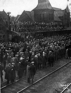 Crowd at Ann Arbor train station sending off football team, 1914