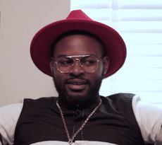 Falz wearing a red hat and a pair of round lens glasses