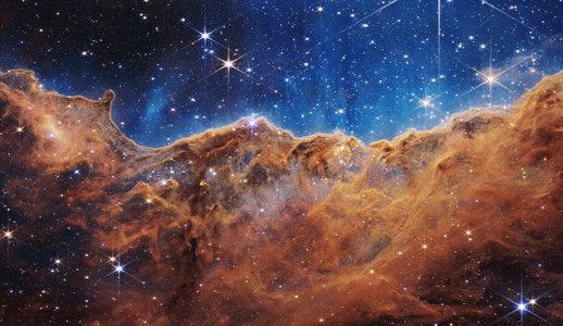 NASA’s Webb Reveals Cosmic Cliffs, Glittering Landscape of Star Birth