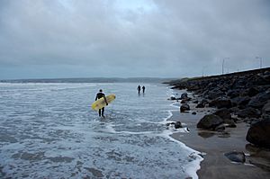 Surfers on their way out to surf Lahinch, December 2012.