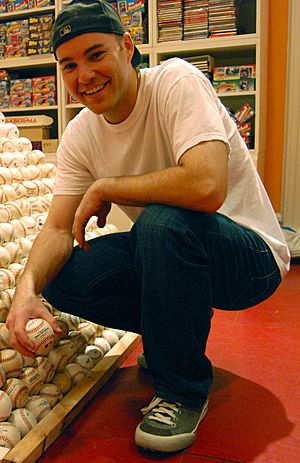 Zack Hample posing with a pyramid of baseballs (cropped).jpg