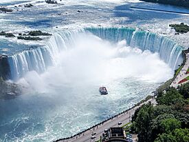 Aerial view of the Canadian Falls (Horseshoe Falls) and the Hornblower Niagara Cruises boat; Niagara Falls.JPG