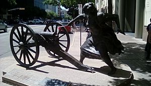Bronze statue of a woman firing a cannon