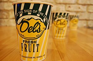Three paper cups with the Del's Lemonade logo on a wooden table