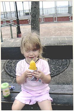 Little girl eating piragua