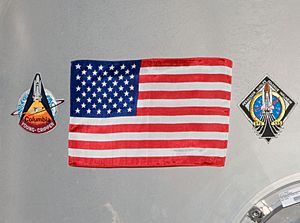 STS-135 Harmony's hatch with U.S. flag - closeup - cropped