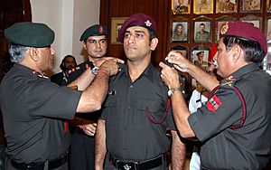 The Chief of Army Staff, Gen. V.K. Singh pipping in the Rank of Hon. Lt. Col. to Indian Skipper M.S. Dhoni, in New Delhi on November 01, 2011