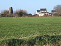 View across fields to disused windmill - geograph.org.uk - 649580