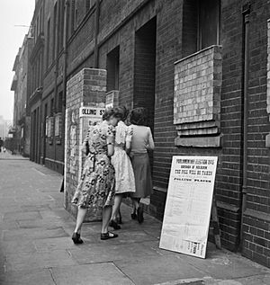 Voters arriving at a polling station in the Italian Hospital, Queen Square, Holborn, London to cast their vote in the General Election of 1945. D25102