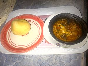 Eba served with Fresh fish banga soup in a clay pot
