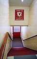 steps leading down to tunnel, above the tunnel is a sign with This Is Anfield in white letters on a red background, with a crest on it