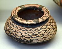Handmade pottery jar. The surface is painted with lustrous black paint on a salmon-pink slip. From Tell Arpachiyah, Iraq. Halaf period, 6000-5000 BCE