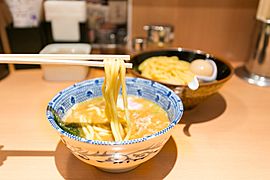 Tsukemen noodles being dipped