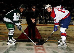 US Navy 081101-N-9898L-063 Capt. Patrick Hall, commanding officer of the aircraft carrier USS Abraham Lincoln (CVN 72), drops the ceremonial puck before a local hockey game