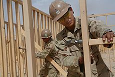 US Navy 090513-M-6882R-233 Navy Petty Officers 1st Class John Cid, from Quezon City, Philippines, and Thomas Damron, from Port Hueneme, Calif., frame walls of the Regimental Combat Team 3 Combat Operations Center