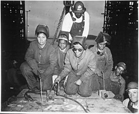 Welders Alivia Scott, Hattie Carpenter, and Flossie Burtos await an opportunity to weld their first piece of steel - NARA - 535800