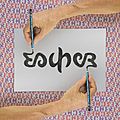 Ambigram Escher and tessellation background - photomontage with reversible hands