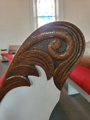 Detail of a carved pew scroll in Chesterville Community Church