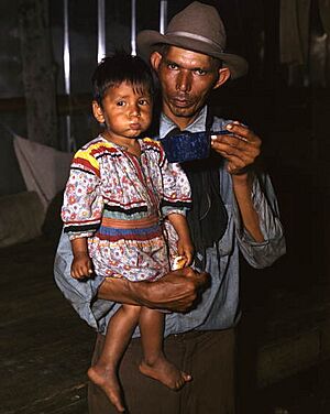 Father and son at a barbeque during the annual cattle round-up- Big Cypress Reservation, Florida (9076358650) (cropped)
