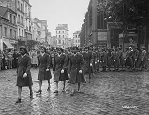 Members of the 6888th Central Postal Directory Battalion take part in a parade ceremony in honor of Joan d'Arc