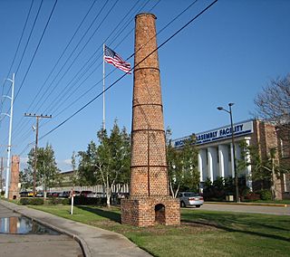 Old plantation smokestacks stand outside the administration offices of NASA's Michoud Assembly Facility, c.2006.