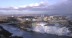The city of Niagara Falls. In the foreground are the waterfalls known as the American Falls and Bridal Veil Falls, respectively, from left to right.