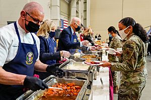President Joe Biden and First Lady Jill Biden serve an early Thanksgiving meal to service members and military families at Fort Liberty