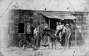 StateLibQld 1 175087 Family in front of house made of kerosene tins at Wakerley, Brisbane, 1927