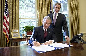 With Sen. Bill Frist (R-Tenn.) looking on, President George W. Bush signs into law S-3728, the North Korea Nonproliferation Act of 2006, Friday, Oct. 13, 2006, in the Oval Office