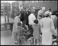 Woodland, California. Farm families of Japanese ancestry waiting at the railroad station for the sp . . . - NARA - 537809