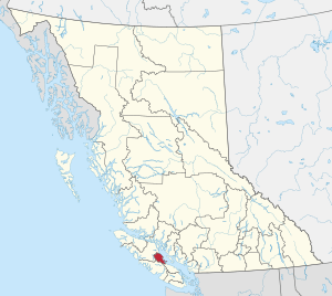 A map of British Columbia depicting its 29 regional districts and equivalent municipalities. One is highlighted in red.