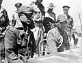 COLLECTIE TROPENMUSEUM In de haven van Kupang (Timor) luisteren de Japanse bevelhebber kolonel Kaida Tatuichi en zijn stafcommandant majoor Muiosu Slioji aan dek van H TMnr 10001519