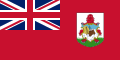 Red flag with Union Flag as top-left quarter and crest on right side.