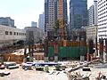 Millennium Tower (301 Mission Street) SF under construction, showing the crane footing, concrete core and construction equipment. The Transbay Terminal is visible to the left