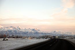 Southbound George Parks Highway approaching the Trunk Road interchange.  The Chugach Mountains and Mat-Su Regional Medical Center are in the background.