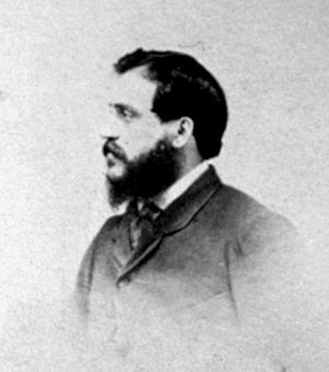 A head-and-shoulders photograph of Beato in profile. He is facing towards the left of the frame and has a full beard.