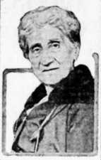 A black-and-white photograph of the head and shoulders of a woman