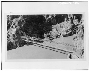 NEW STEEL BRIDGE COMPLETED ASSEMBLED. OLD BRIDGE BELOW. U.S.G.S. GAGING STATION IN RIGHT BACKGROUND. VIEW LOOKING NORTHEAST - Kaibab Trail Suspension Bridge, Spanning Colorado HAER ARIZ,3-GRACAN,3-26