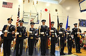 U.S. Airmen with the Kadena Air Base honor guard present the U.S. and service flags during Kadena Air Base (AB) Special Olympics opening ceremony at Kadena AB in Okinawa, Japan, Nov 111105-F-ZT401-386