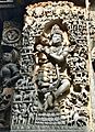 12th-century Krishna playing flute with gathered living beings lost in music at Shaivism Hindu temple Hoysaleswara arts Halebidu Karnataka India